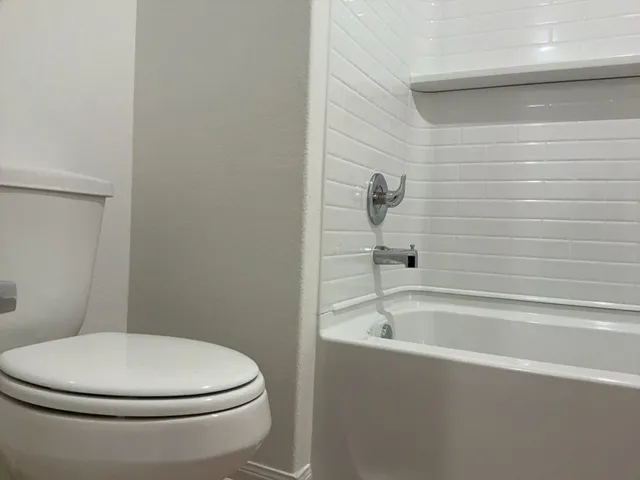 an empty room with closet and a window