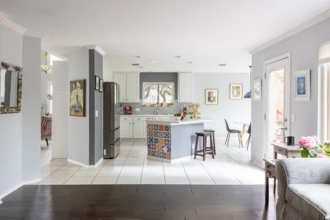 a living room with furniture a refrigerator and a dining table