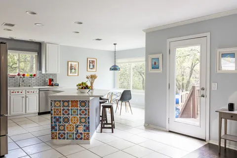 a living room with furniture a dining table and a window