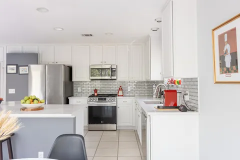 a kitchen with a sink appliances and cabinets