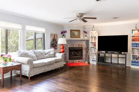 a living room with furniture a flat screen tv and a fireplace