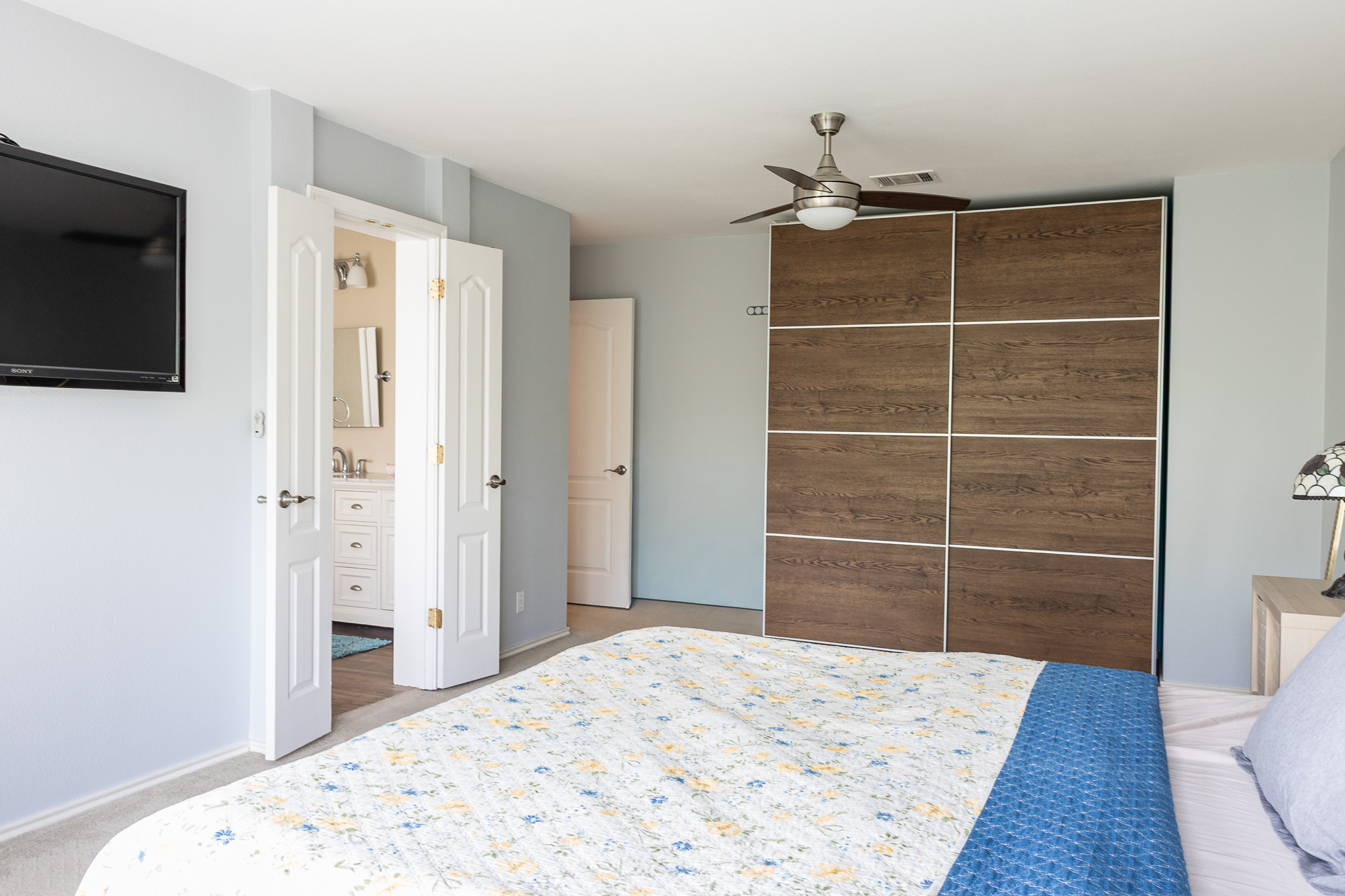 3704 Caney Creek Road Austin, TX 78732 - Photo 19 of 38 a bedroom with a bed and a flat screen tv