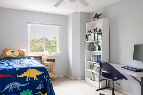 a bedroom with a bed and a window
