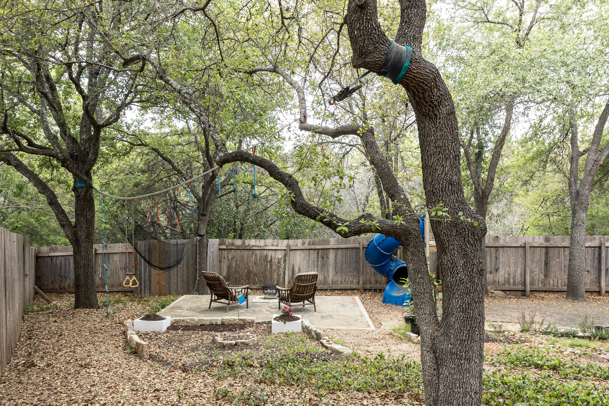 3704 Caney Creek Road Austin, TX 78732 - Photo 32 of 38 a backyard of a house with barbeque oven