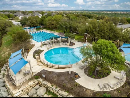 a view of a swimming pool with a yard