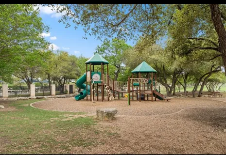 a view of a park with swings and slides
