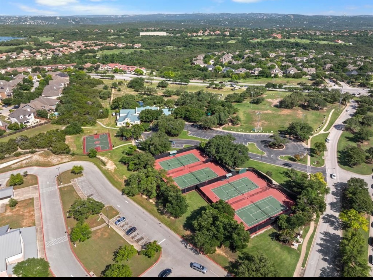 3704 Caney Creek Road Austin, TX 78732 - Photo 37 of 38 an aerial view of residential houses with outdoor space and trees