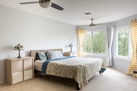 a bedroom with a bed and a window