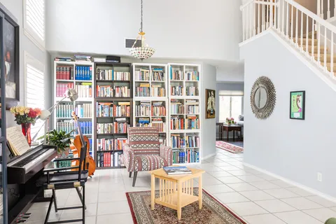 a living room with furniture a rug and white walls