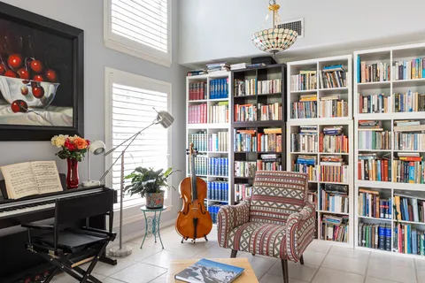 a living room with furniture and a book shelf