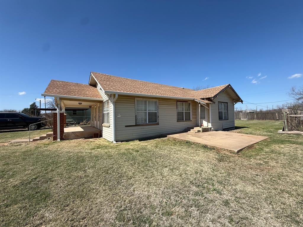 618 12th Street Anson, TX 79501 - Photo 2 of 3 a view of a house with a yard and garage