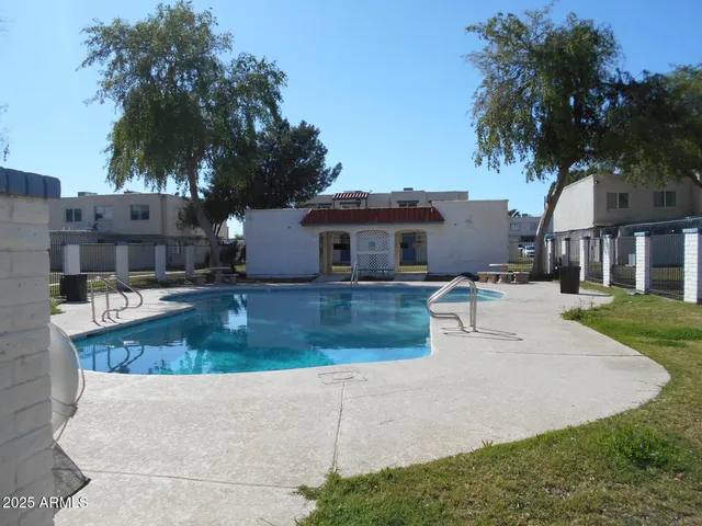 a view of a house with a yard and palm tree