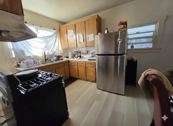 a kitchen with stainless steel appliances granite countertop a refrigerator and a stove