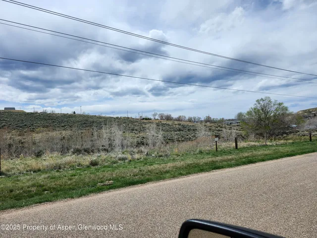 a view of a city street with a yard