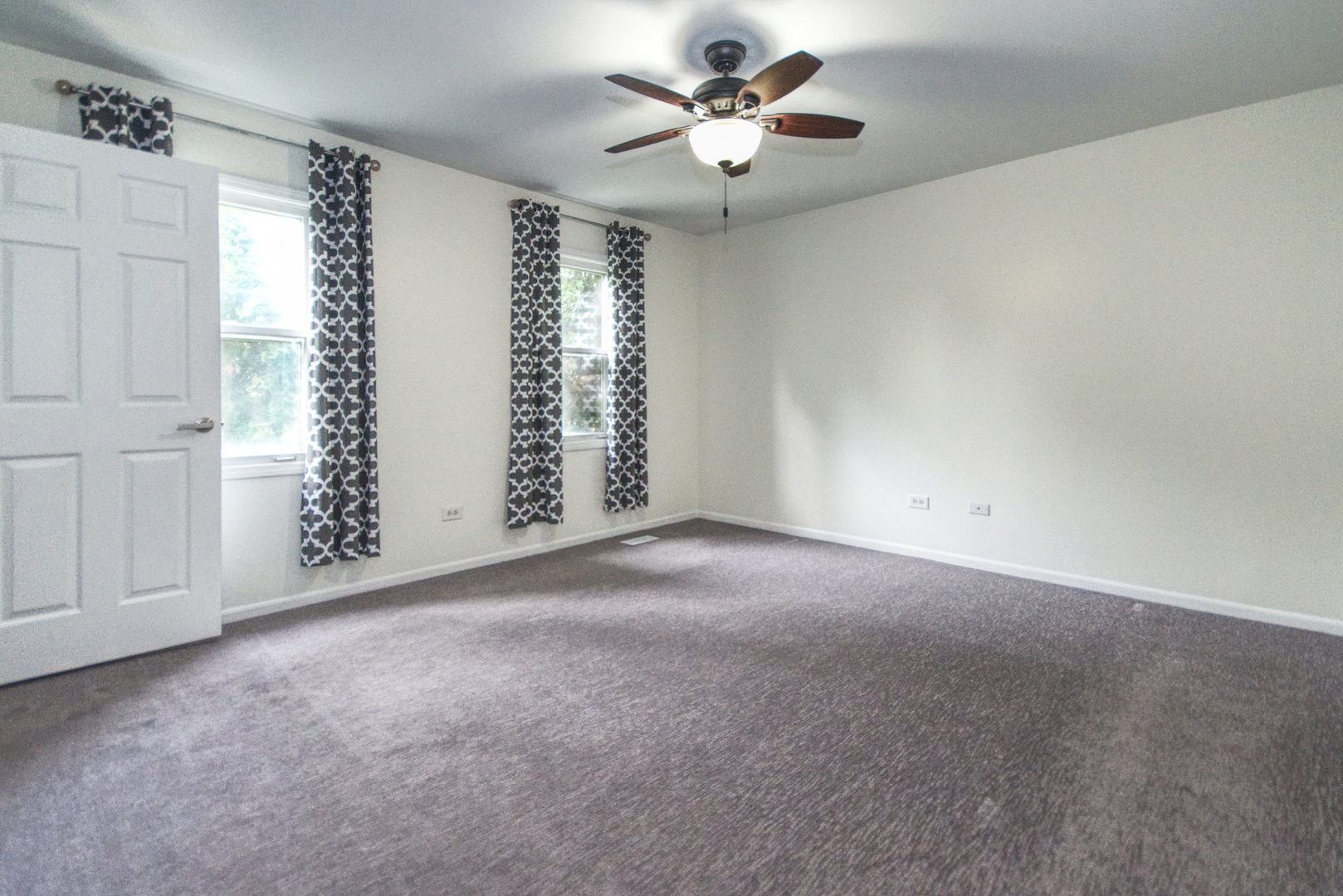 2312 Verdun Drive Joliet, IL 60435 - Photo 11 of 24 an empty room with windows and chandelier fan
