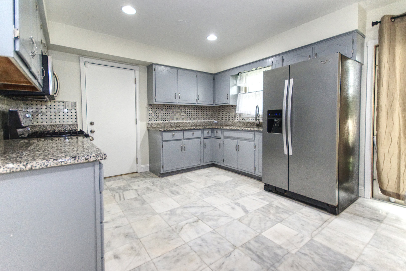 2312 Verdun Drive Joliet, IL 60435 - Photo 7 of 24 a kitchen with stainless steel appliances granite countertop a refrigerator and a stove top oven