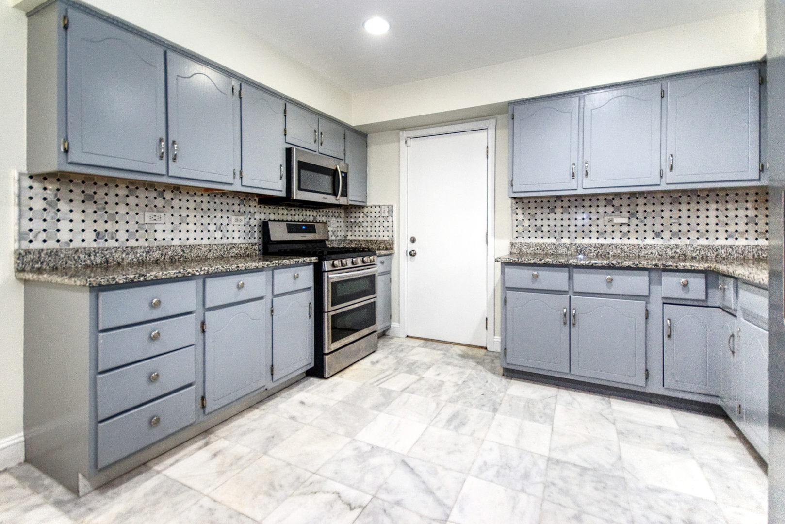 2312 Verdun Drive Joliet, IL 60435 - Photo 8 of 24 a kitchen with stainless steel appliances granite countertop a stove a sink and a refrigerator