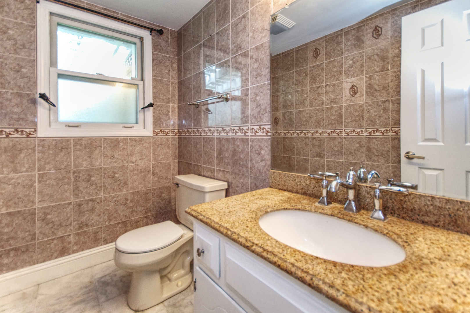 2312 Verdun Drive Joliet, IL 60435 - Photo 10 of 24 a bathroom with a granite countertop toilet a sink and a mirror