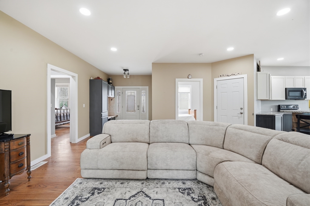 96 Stafford Hollow Road Monson, MA 01057 - Photo 13 of 39 a living room with furniture and a flat screen tv