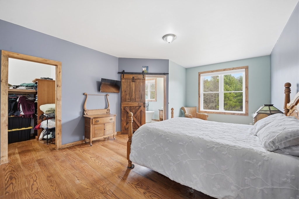 96 Stafford Hollow Road Monson, MA 01057 - Photo 18 of 39 a bedroom with a bed and a large window