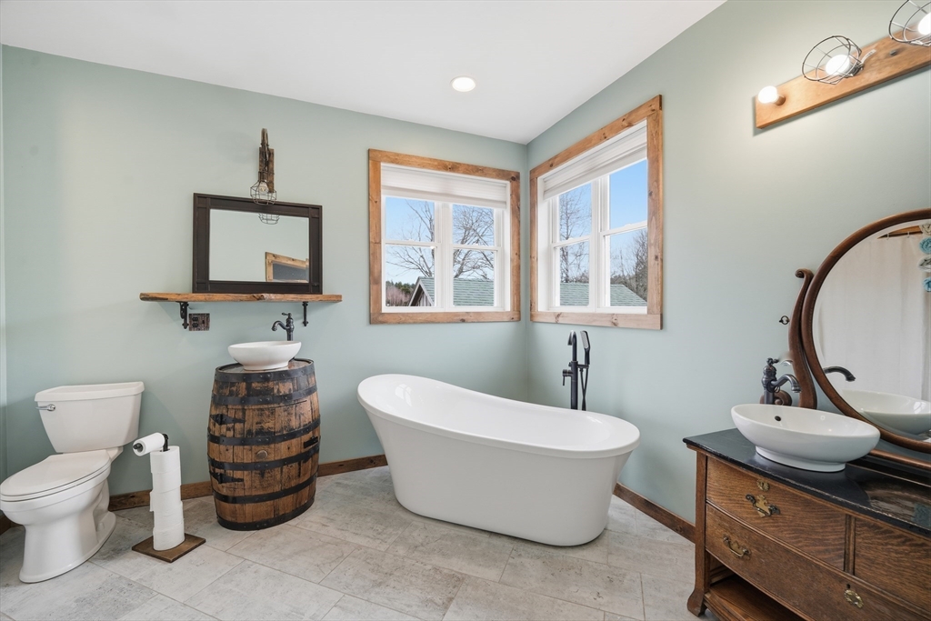 96 Stafford Hollow Road Monson, MA 01057 - Photo 20 of 39 a bathroom with a toilet a sink and a mirror