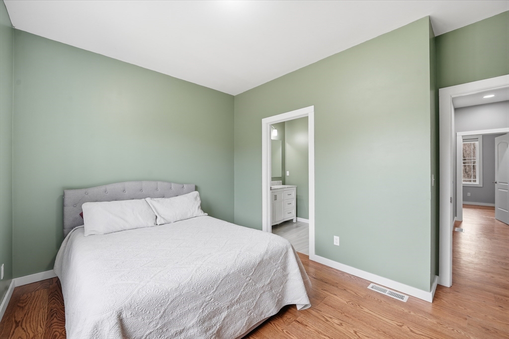 96 Stafford Hollow Road Monson, MA 01057 - Photo 26 of 39 a bedroom with a bed and wooden floor