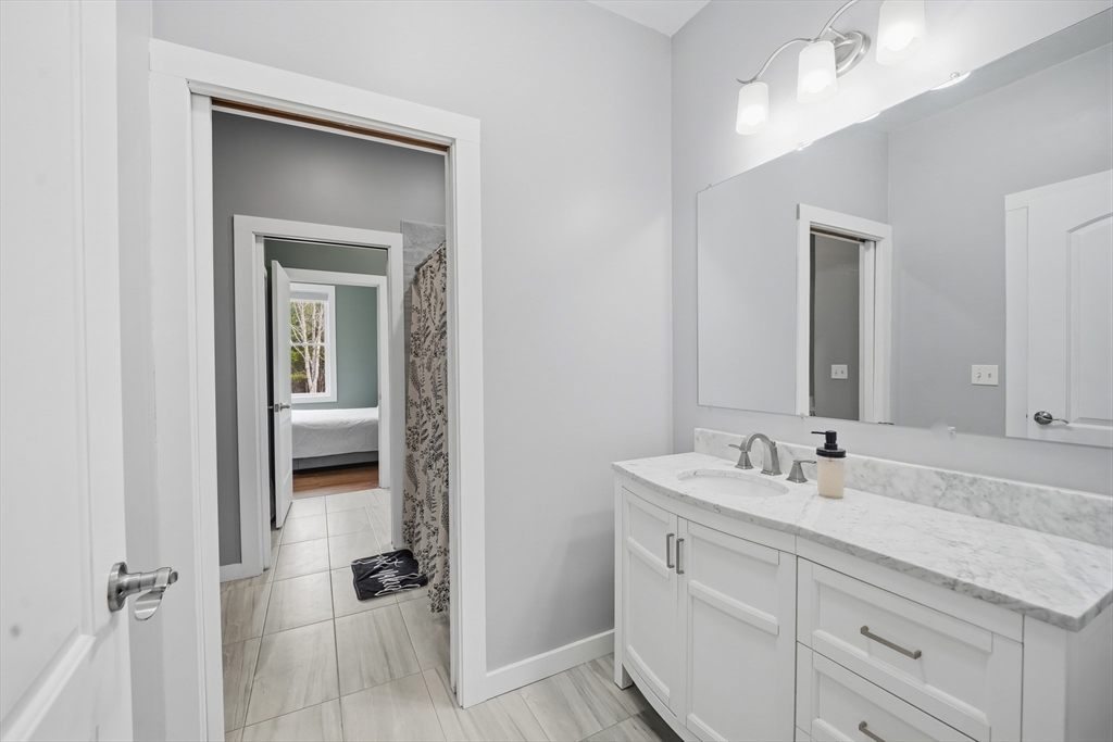 96 Stafford Hollow Road Monson, MA 01057 - Photo 29 of 39 a bathroom with a double vanity sink and mirror