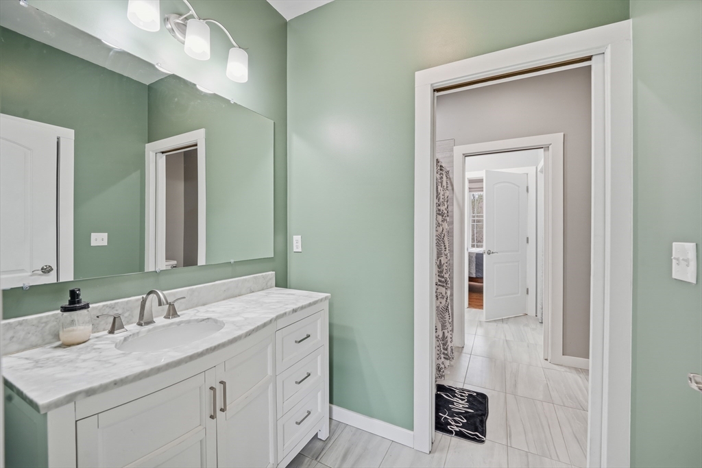 96 Stafford Hollow Road Monson, MA 01057 - Photo 30 of 39 a bathroom with a sink vanity and a mirror