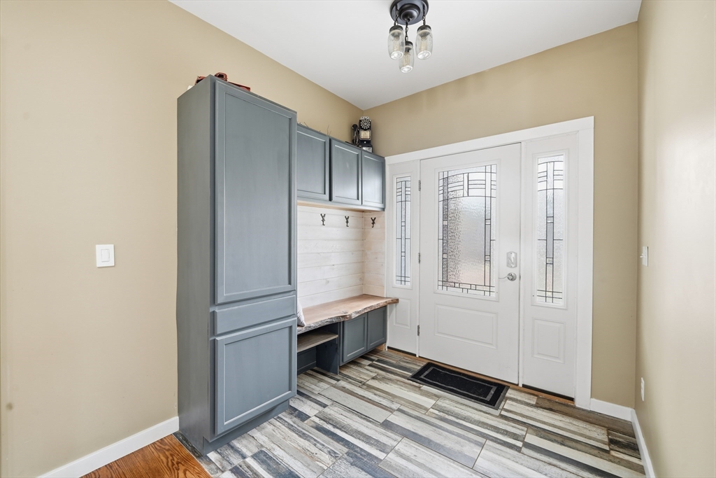 96 Stafford Hollow Road Monson, MA 01057 - Photo 5 of 39 a view of a refrigerator in kitchen and an empty room with wooden floor