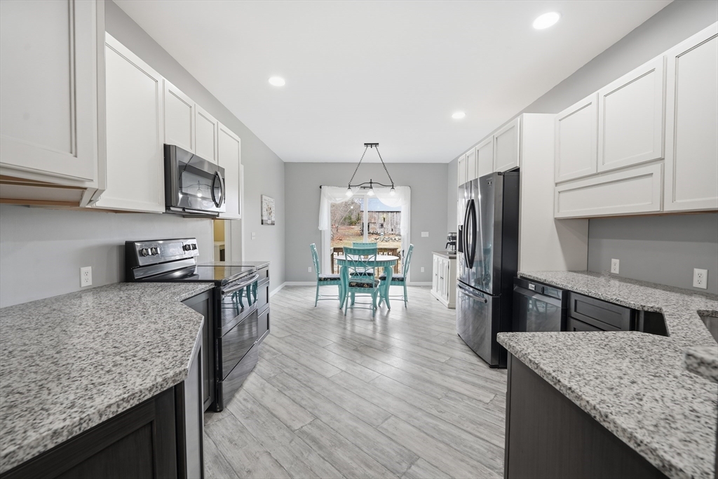 96 Stafford Hollow Road Monson, MA 01057 - Photo 7 of 39 a kitchen with stainless steel appliances granite countertop a stove refrigerator and a wooden cabinets