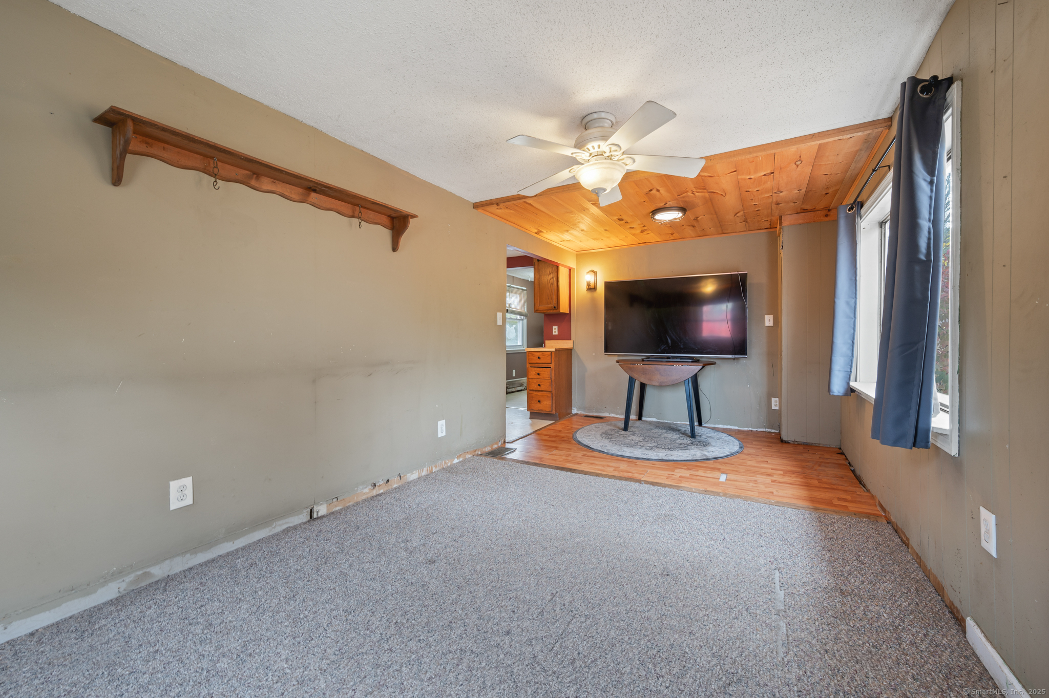 322 Crystal Lake Road Tolland, CT 06084 - Photo 12 of 29 a view of a livingroom with wooden floor and a ceiling fan