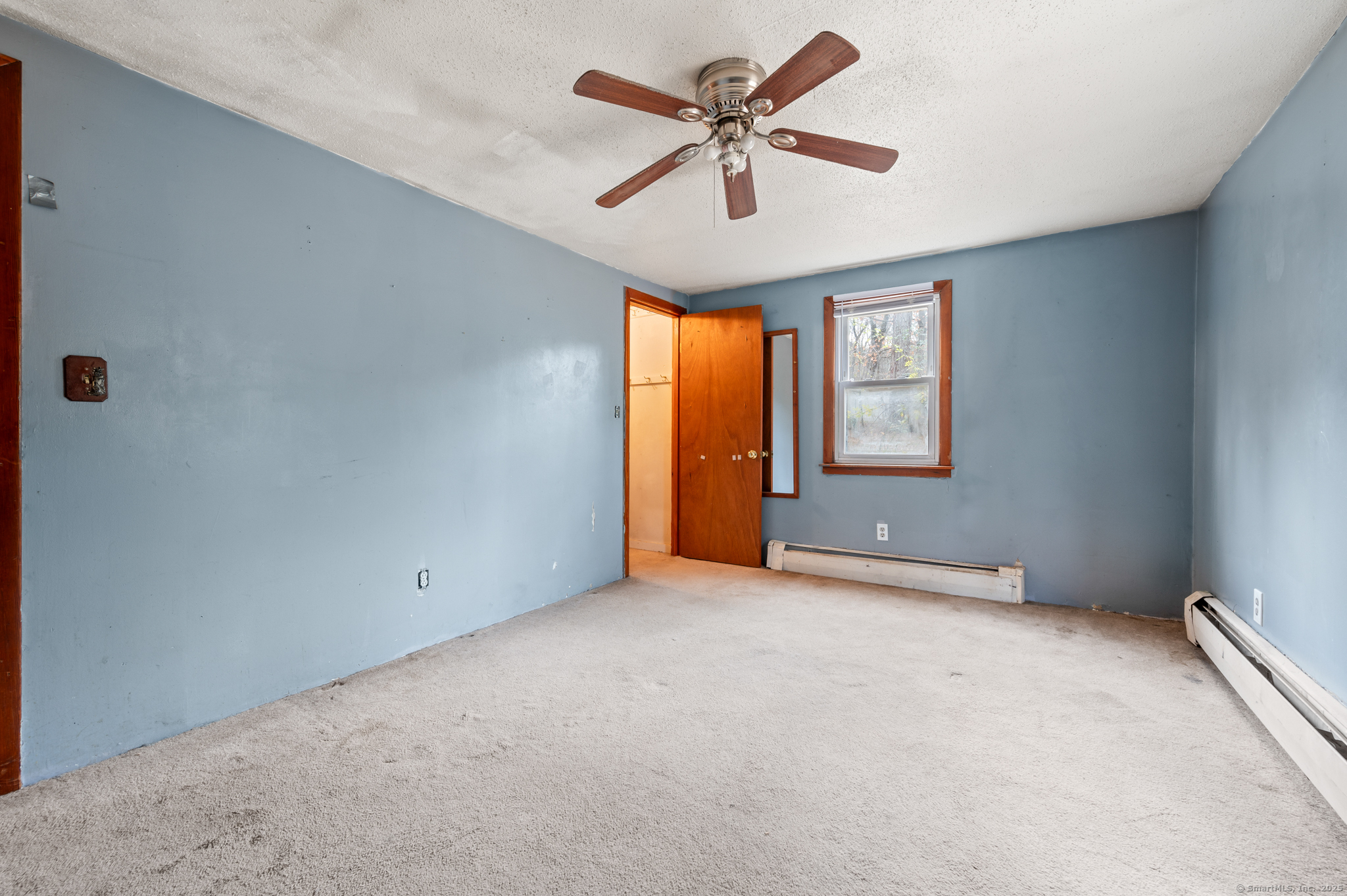 322 Crystal Lake Road Tolland, CT 06084 - Photo 16 of 29 an empty room with windows and fan
