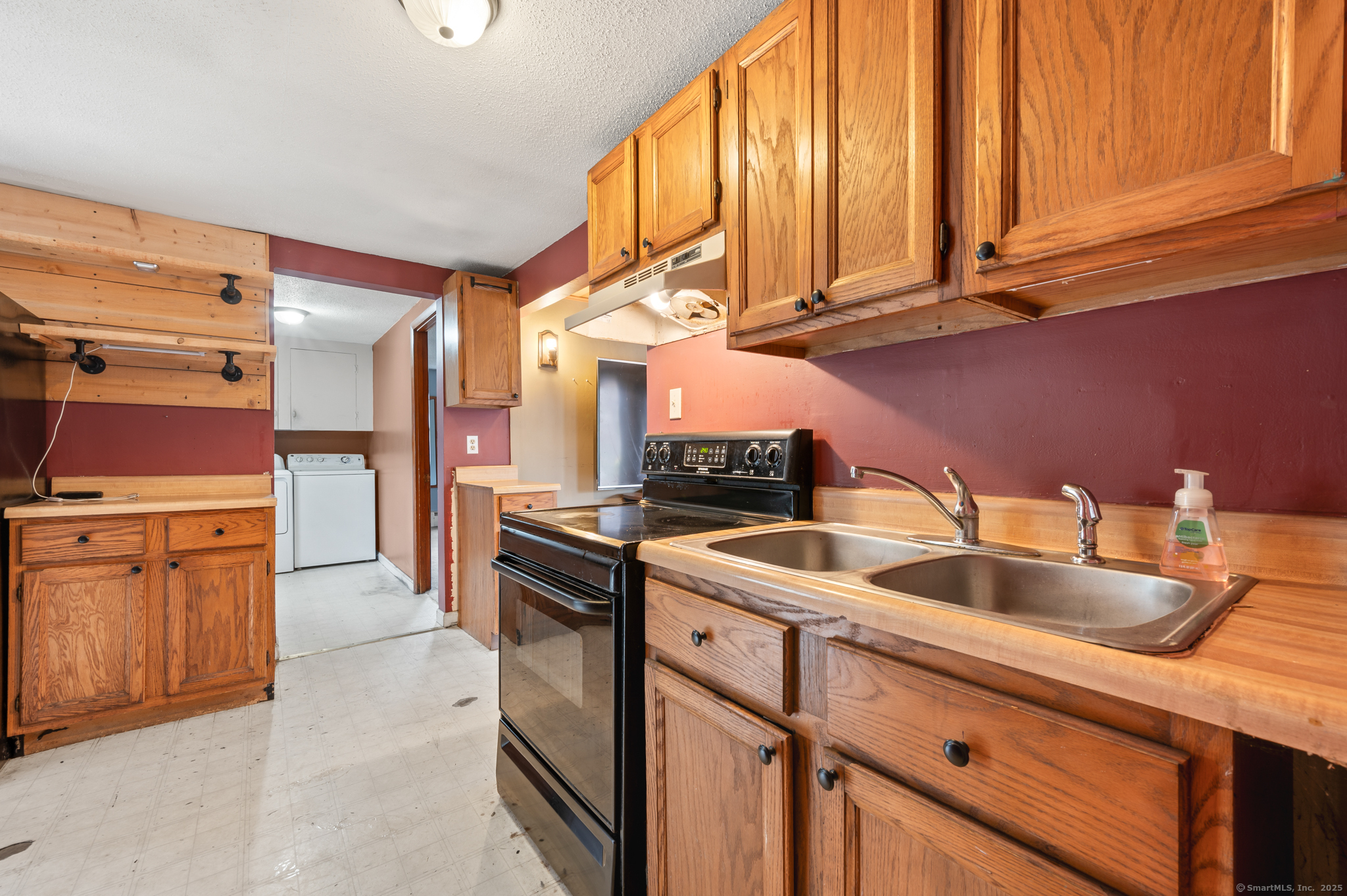 322 Crystal Lake Road Tolland, CT 06084 - Photo 23 of 29 a kitchen with white cabinets and sink