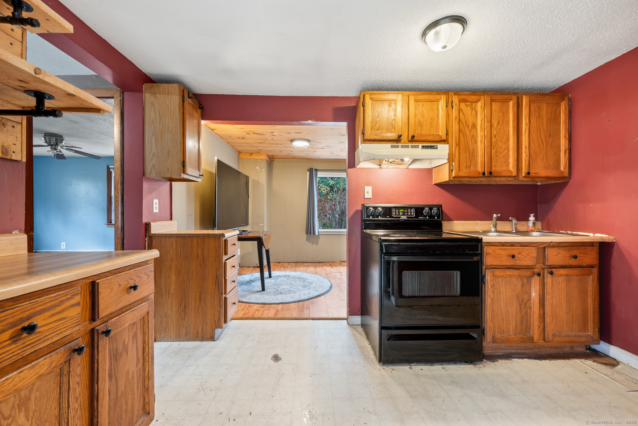 322 Crystal Lake Road Tolland, CT 06084 - Photo 25 of 29 a kitchen with stainless steel appliances granite countertop a stove a sink and a microwave