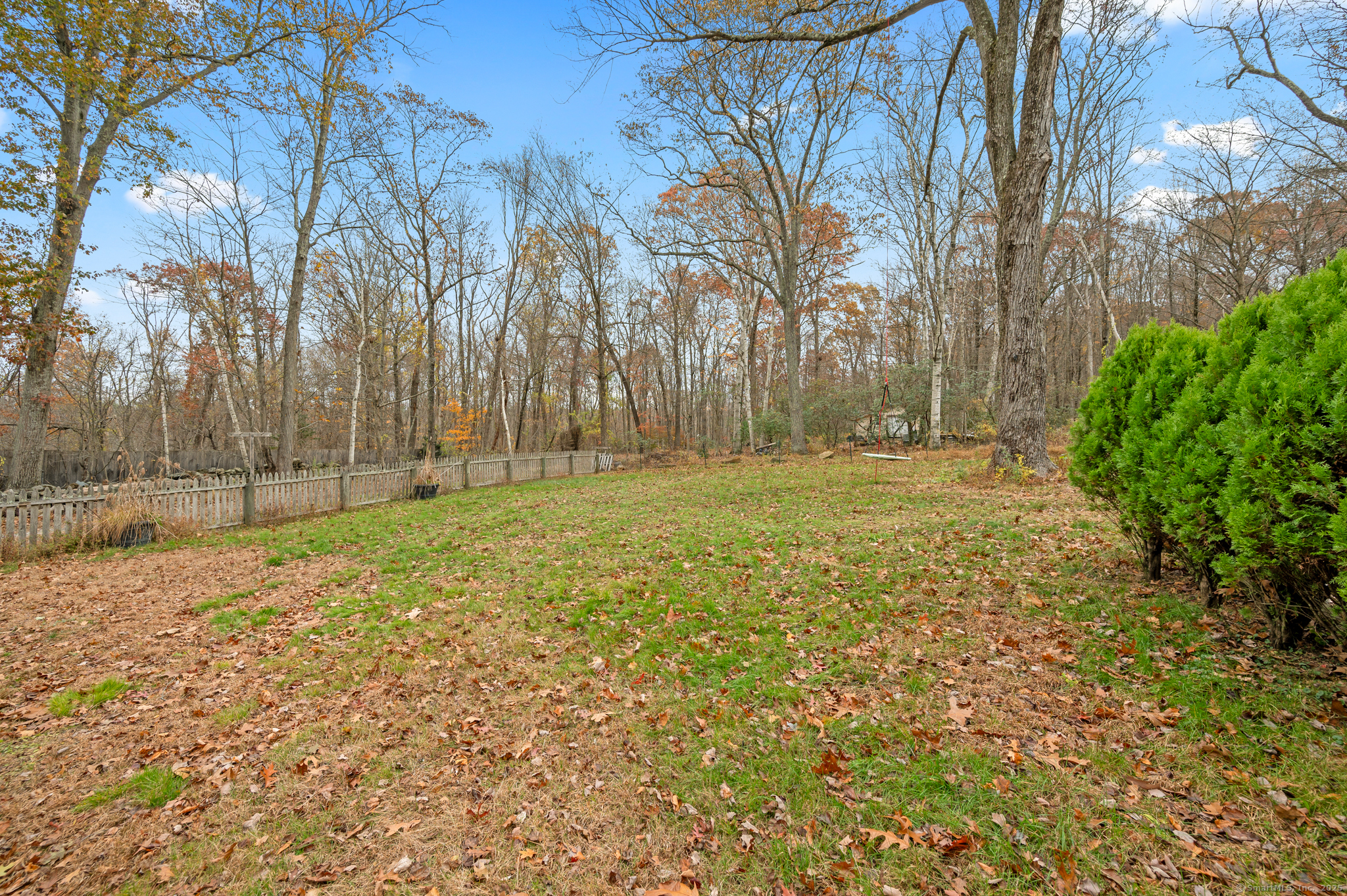 322 Crystal Lake Road Tolland, CT 06084 - Photo 7 of 29 a view of a field with trees in the background