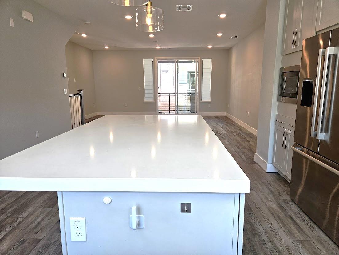 122 Ranch Lane Mountain View, CA 94040 - Photo 6 of 20 a view of a kitchen with a sink refrigerator and wooden floor
