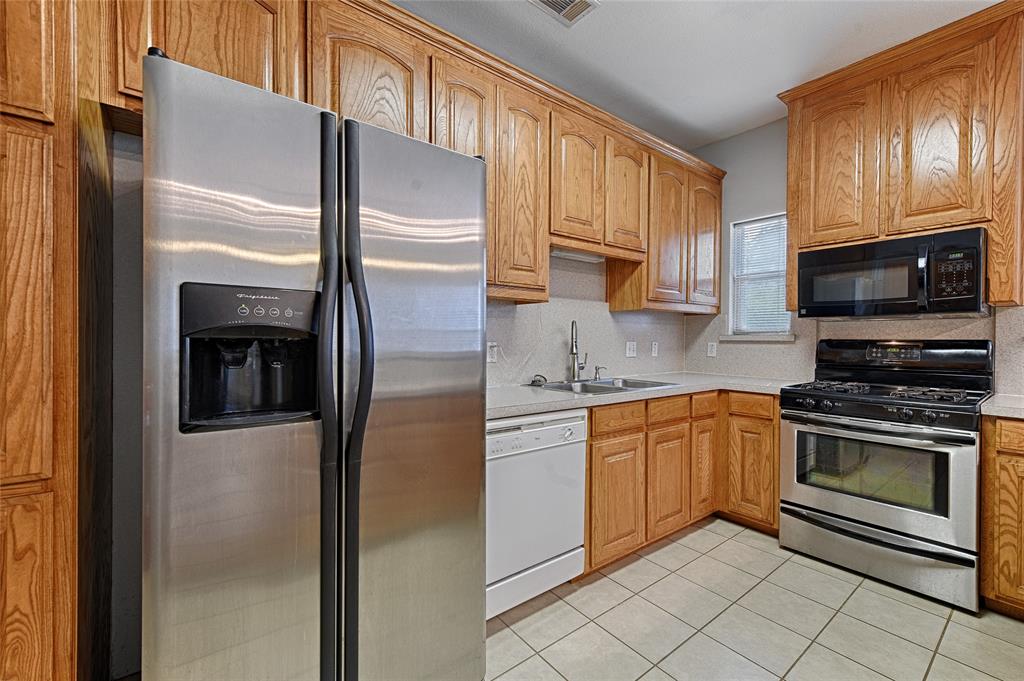 400 Dale Hollow Road Fort Worth, TX 76103 - Photo 11 of 29 a kitchen with stainless steel appliances granite countertop a refrigerator stove and sink