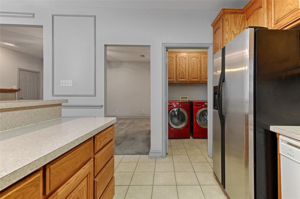 400 Dale Hollow Road Fort Worth, TX 76103 - Photo 13 of 29 a kitchen with a refrigerator and a sink