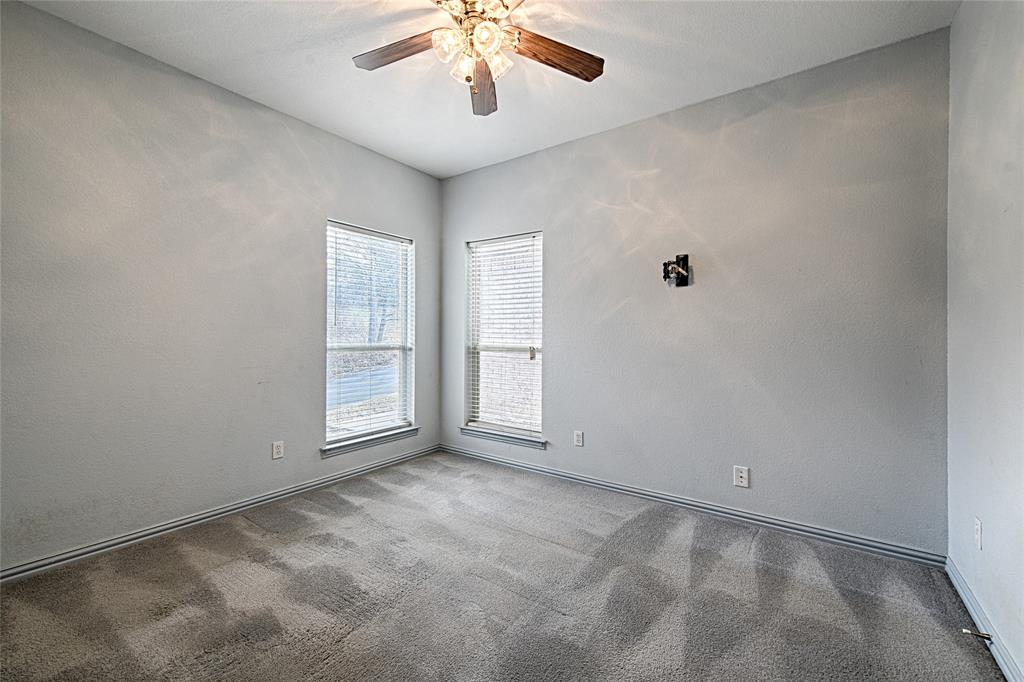 400 Dale Hollow Road Fort Worth, TX 76103 - Photo 16 of 29 an empty room with chandelier fan and windows