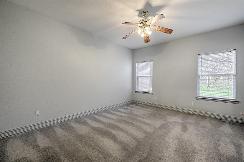 400 Dale Hollow Road Fort Worth, TX 76103 - Photo 21 of 29 an empty room with windows and chandelier fan