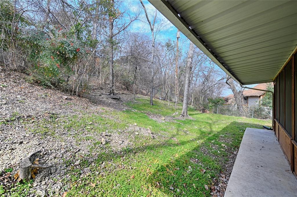 400 Dale Hollow Road Fort Worth, TX 76103 - Photo 27 of 29 a backyard of a house with plants and large trees