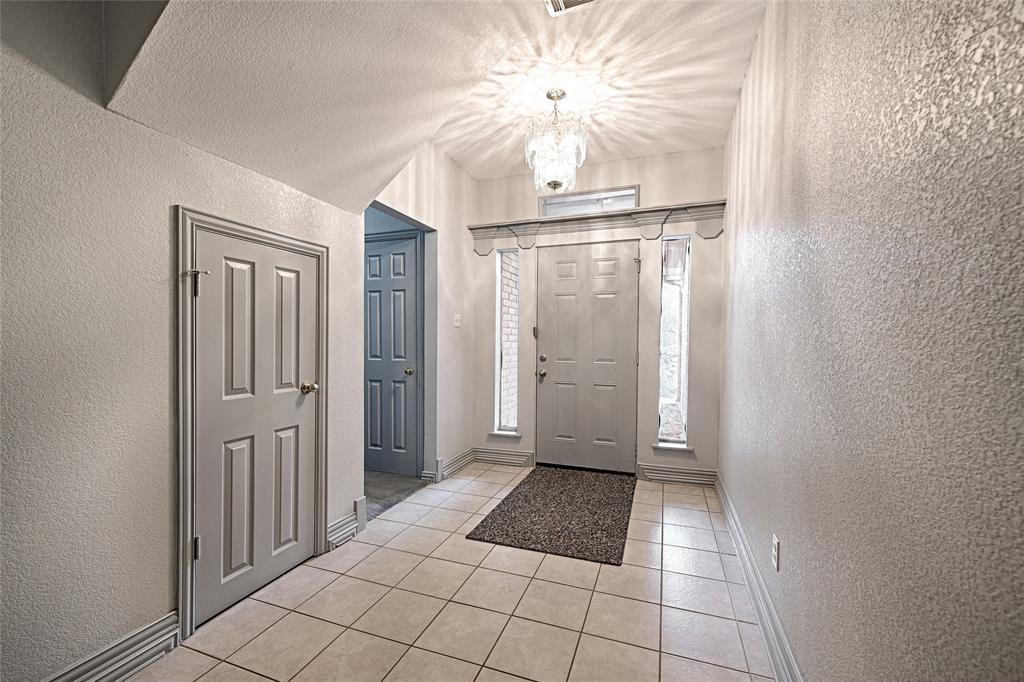 400 Dale Hollow Road Fort Worth, TX 76103 - Photo 5 of 29 a view of a hallway with a chandelier fan and fire place