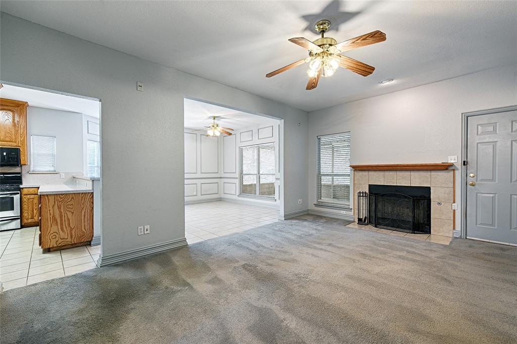 400 Dale Hollow Road Fort Worth, TX 76103 - Photo 6 of 29 a view of an empty room with a fireplace and a window