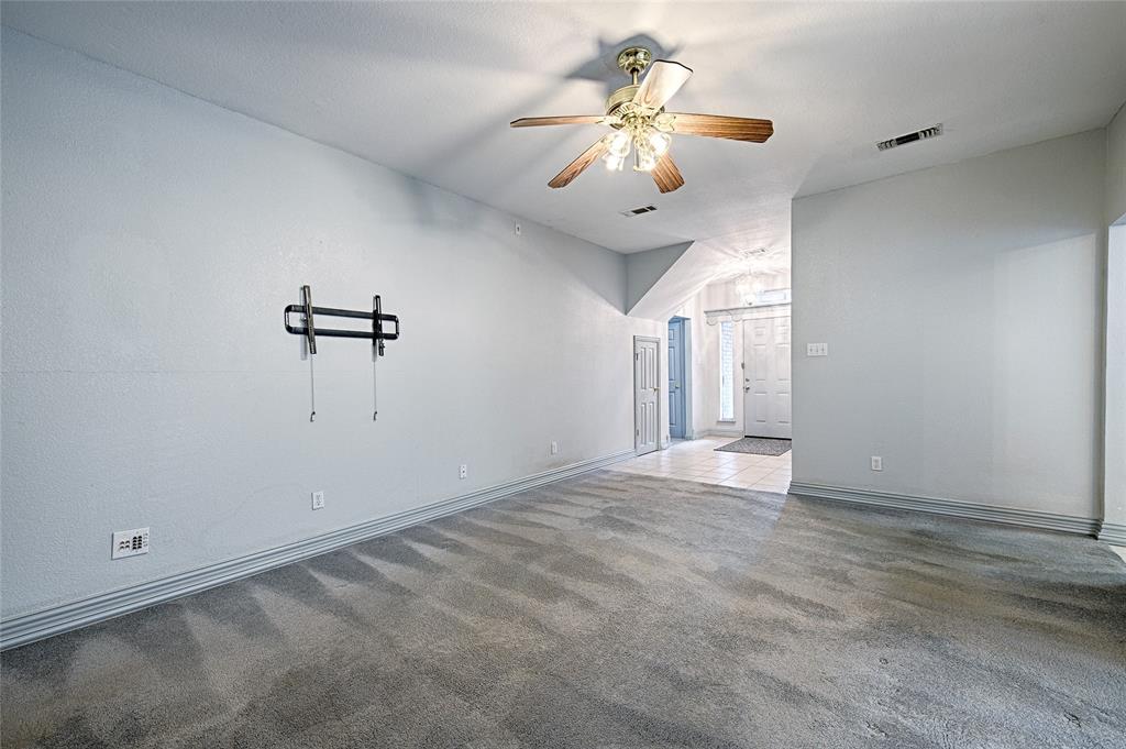 400 Dale Hollow Road Fort Worth, TX 76103 - Photo 7 of 29 an empty room with a chandelier fan and windows