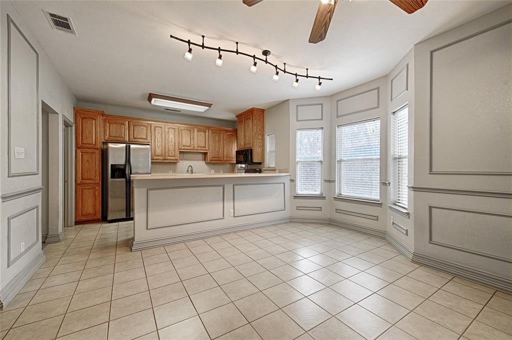 400 Dale Hollow Road Fort Worth, TX 76103 - Photo 10 of 29 a kitchen with stainless steel appliances granite countertop a refrigerator and a stove top oven