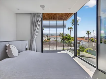 a bedroom with a bed and a large window