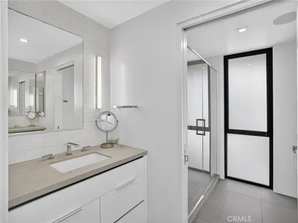 a spacious bedroom with a bed and a dresser next to a window