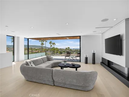 a living room with furniture couches and kitchen view