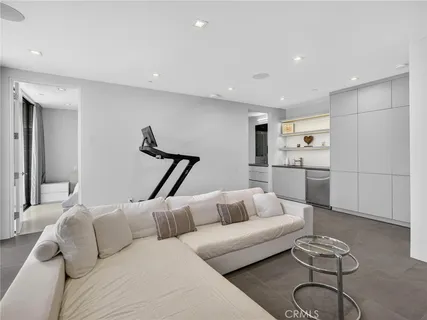 a living room with furniture a rug and white walls