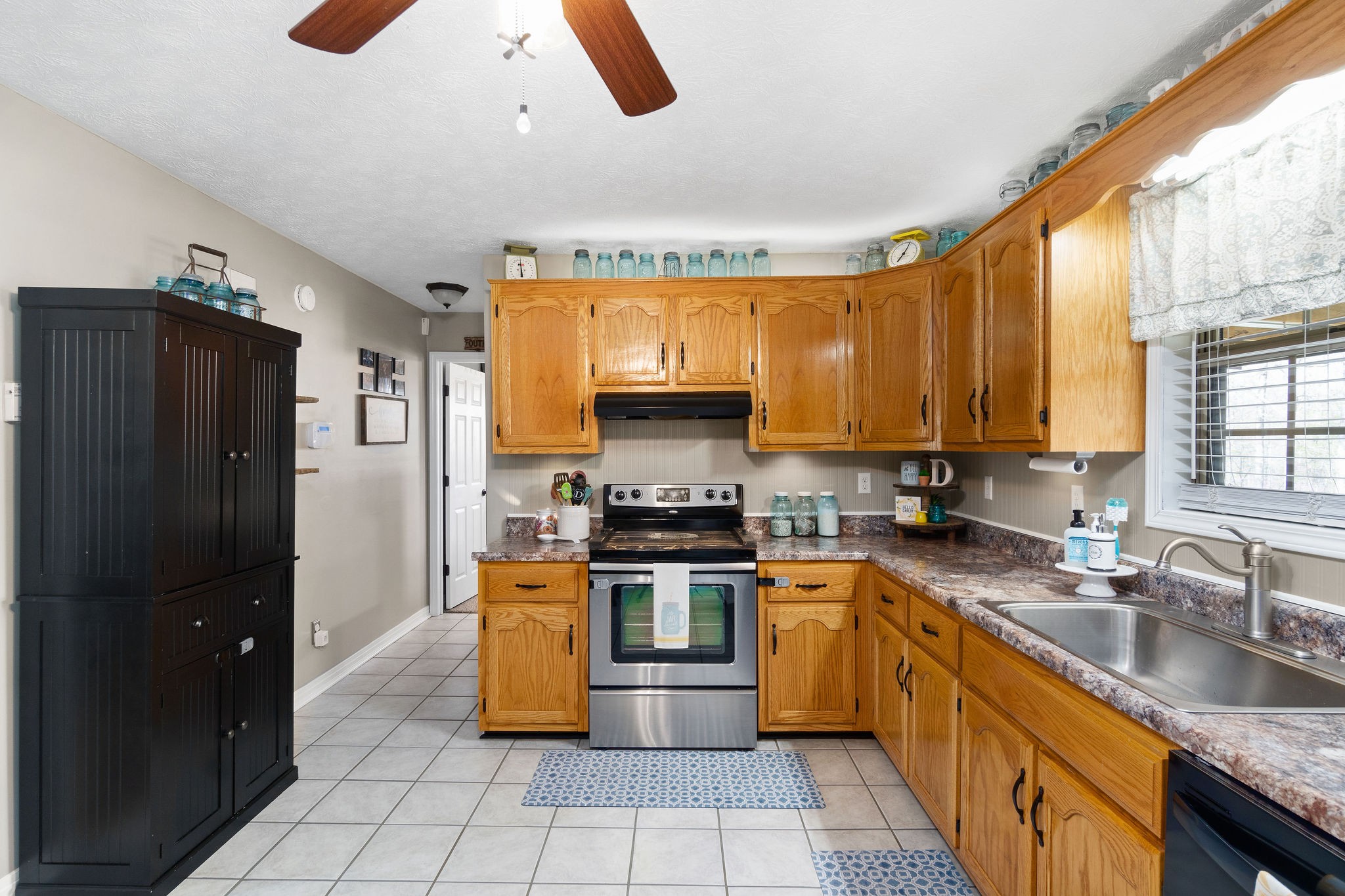 2868 Waverly Road Tennessee Ridge, TN 37178 - Photo 11 of 33 a kitchen with stainless steel appliances granite countertop a stove a sink and a refrigerator
